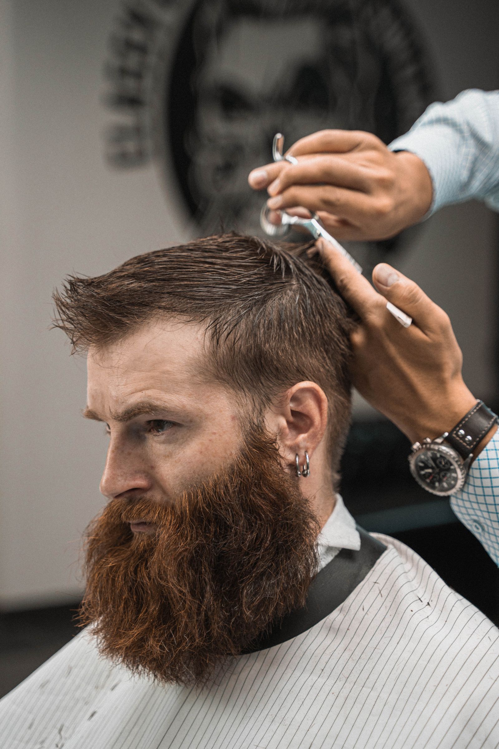 Barber trimming a client's beard