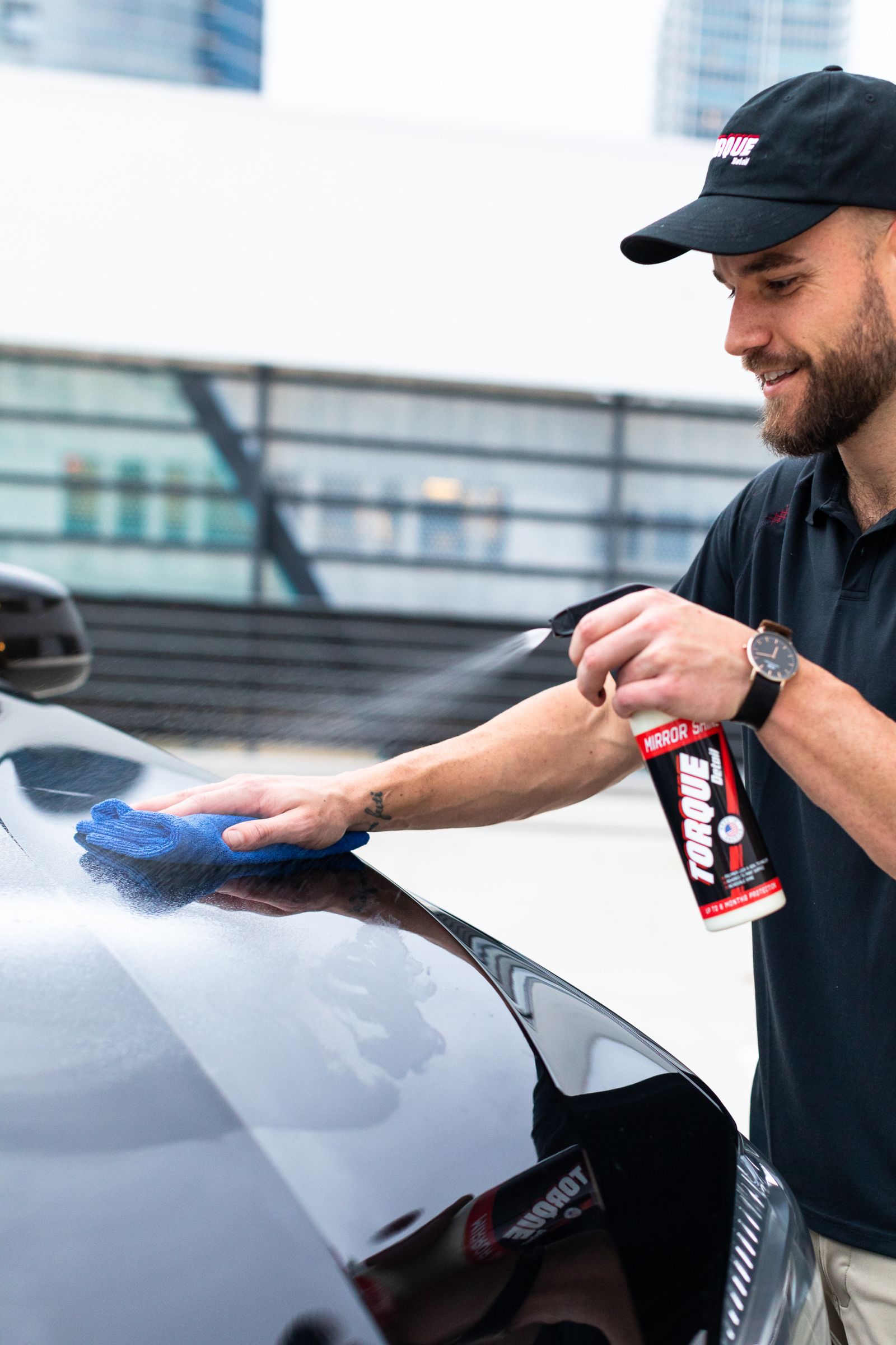 Detailer wiping down a car